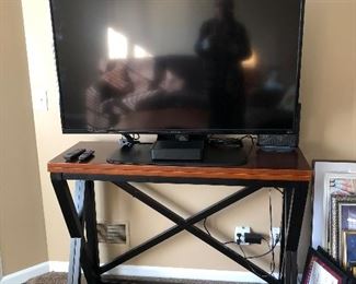 48" Island height table that the 16"  top flips over to make 48X32" top size.  Clients are just using as a tv stand/console table.  The LG Insignia LED 32LD350-UB is for sale