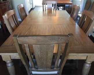 Large farm table with six chairs with drop down center leaf.