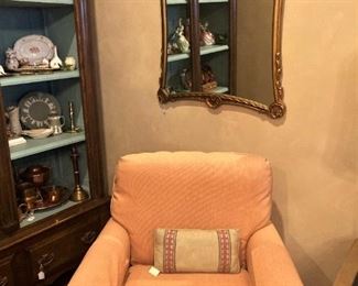One of two matching peach-colored chairs
