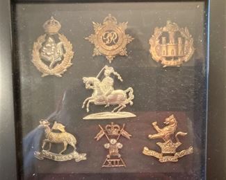 Vintage cap badges in display case