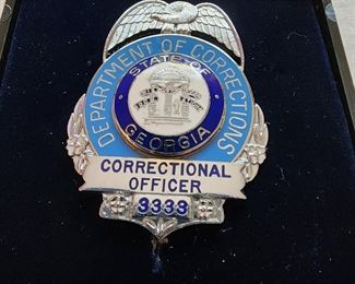 State of Georgia Department of Corrections badge.