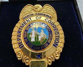 North Carolina Department of Corrections badge.