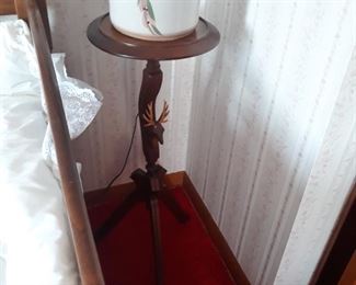 Plant stand with carved figural image