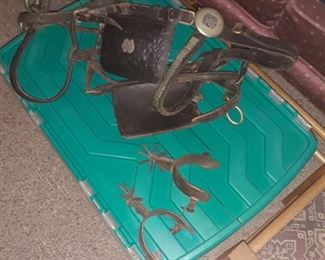 Western spurs
And
Horse halter with blinds
Has a monogram on it no less