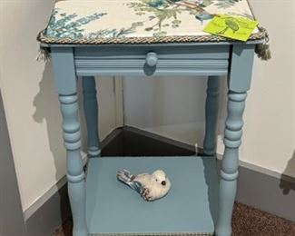 Blue tapestry table with bird.