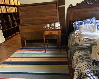 Several beds, night stand and boatloads of linens.