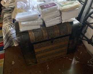 Linens on antique trunk