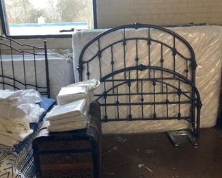Two metal double beds with mattress and box springs.
