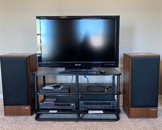 Entertainment Center featuring 40" Sharp Aquos LCD TV, Infinity Tower Speakers, CD Player, Amp and Stand