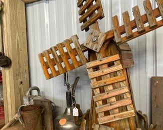 Wooden windmill, oil cans