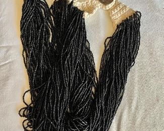 Beaded multi strand necklace with coin clasp 