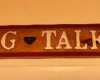 "Sit Long Talk Much" sign 
