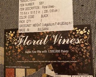 $125 - "Floral Vines" area rug - Black. Measures 7' 8" x 10' 2". 