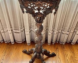 Ornate carved stand for vase 