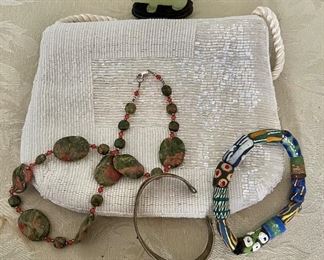 Beaded purse, bangles, necklace, carved pig on stand 