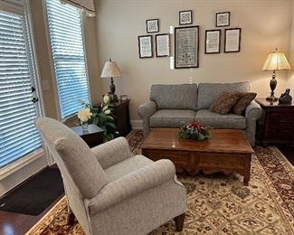 Informal living area with neutral upholstered La-Z-Boy recliner and loveseat 