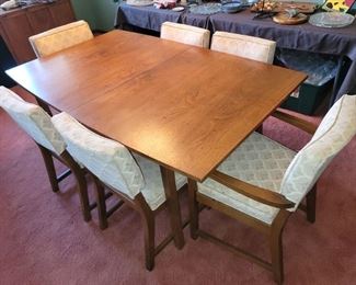 Mid-century Modern Pecan Dining table and six chairs, with pads and extra leaf.  There is a china cabinet and buffet cabinet that match.