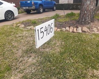 House number posted in yard