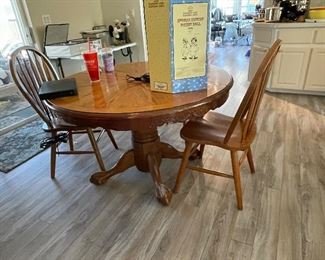 Dining table all wood has a leaf and 3 chairs.