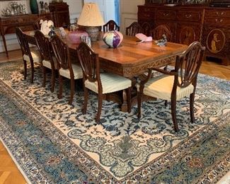 Regency style carved walnut double pedestal dining table. 30'h x 120"w x 44"d. Group of 12 Sheraton style mahogany shield back dining chairs.
