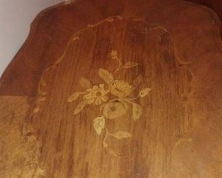 Antique   Top has inlaid flower design and removable framed glass tray. 