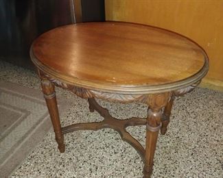 Antique Serving table, Oval design with carved legs and removable framed glass tray.  $375.00