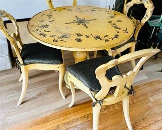 Round pedestal French Provincial style painted table and four woven seat chairs with cushions.