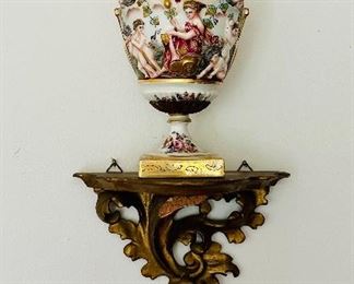 Pair Copodimonte covered urns on gilt wood wall shelf