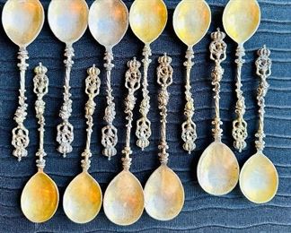 Set of 12 silver neoclassical style spoons with silver gilt bowls. Caryatid supporting laurel and papal crown/crest decoration.