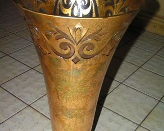 24 inch tall vase, featuring gold-leaf encased in glass,, except for the clear space at the bottom, through which light may pass through the vase, with a clear glass base. Made by an artisan in Mazatlan.