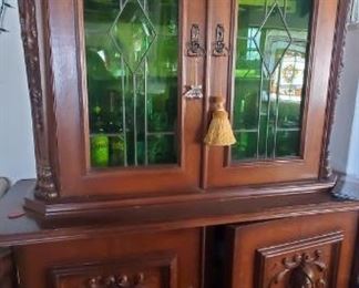 Spanish bar, with handcarved embellishments including warriors heads! c 1850. Glass redone in the 1920's.