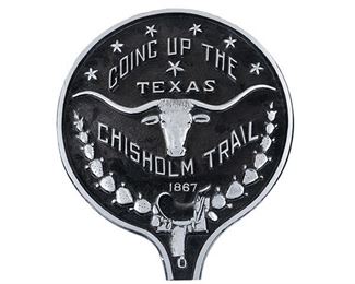 Metal wall plaque reading "Coming Up the Texas Chisholm Trail 1867"