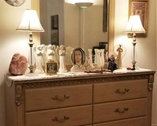 Neutral bedroom set with electric sleep number king bed, 2 matching bedside dressers, tall bureau, and wide dresser with mirror. 