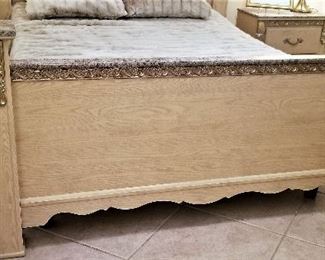 Neutral bedroom set with electric sleep number king bed, 2 matching bedside dressers, tall bureau, and wide dresser with mirror. 