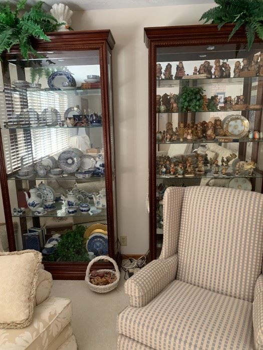 2 matching lighted curio cabinets in a dark mahogony wood with glass shelving.