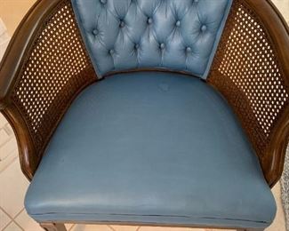 There are 2 of these matching blue upholstered chairs with caning in very good condition.