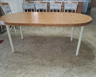 Metal legs formica top, easy to clean is great shape approx 6' table, with 6 matching chairs