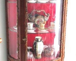 Wonderful rounded curio cabinet.  Brass fitting, and decorative images.  Great condition