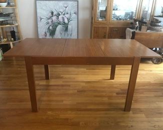 MCM Style  Dining Table with Leaf Storage. As shown above with leaf extension the table measures 33in W x 66in L and 30in H.