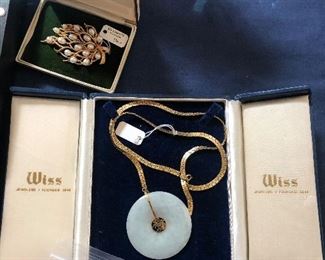 JADE WITH 14K GOLD PENDANT AND BRASS CHAIN.