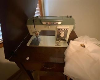White sewing machine with table.  Have 2 sewing machines with tables.  Only 1 pictured. 
