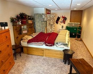 A queen size bed with a Queen
Tempru-pedic mattress , head board, drawers under, comforters, storage crates in the back and the piano bench and the 6 sided Moorish style table on the lower right.