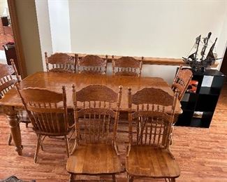 A great looking dinner table with one large leaf.
8 - spindle back, pressed back chairs that just happens to fit around this GREAT dinning room table!! 
Note: the Mayflower off to the right…