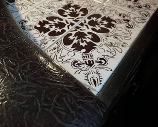 Bar has a tiled cutting area and a top cabinets in the back for storage and a tiled 