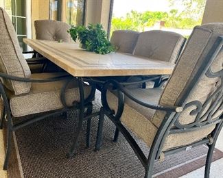 Outdoor patio table with six cushioned chairs
