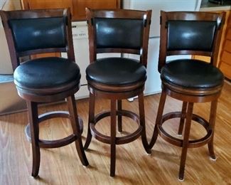Three swivel bar and counter stools