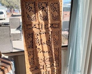 Large intricately carved folding screen