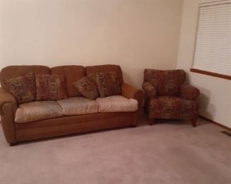 Leather and upholstered couch with upholstered chair.