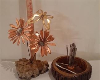 Miscellaneous items. Nut bowl with accessories and metal flowers inside rock