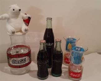 Coca-Cola items. Bottles of Coke, bear, pitcher and candles